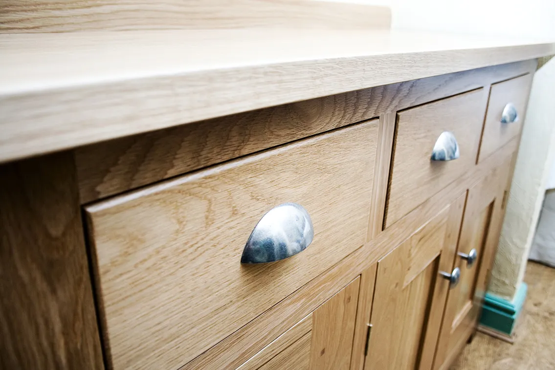Close-up of oak drawers with cup handles